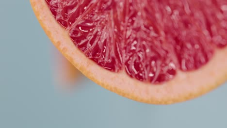 Vertical-video-of-a-close-up-macro-grapefruit-for-background