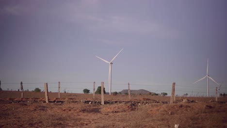 Windmills-spinning-in-a-desert-in-Mui-Ne,-Phan-Thiet,-Vietnam