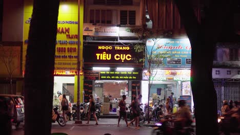 Traffic-Activity-and-Pedestrians-walking-along-a-road-with-Vietnamese-shophouses-in-the-background-in-District-1-Ho-Chi-Minh-City,-Vietnam