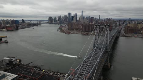 A-high-angle-aerial-view-of-Brooklyn-and-Lower-Manhattan-from-over-the-Williamsburg-Bridge-in-NY-on-a-cloudy-day