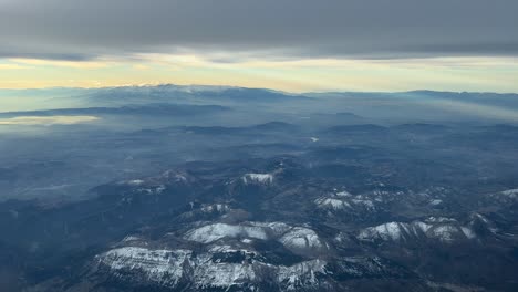 Awesome-snowy-mountain-landscape-at-sunrise:-aerial-view-of-snowy-majestic-peaks-and-hazy-valleys