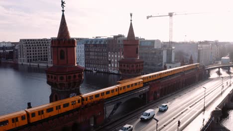 Yellow-metro-trains-pass-each-other-on-double-deck-Oberbaum-bridge