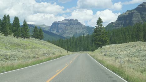 Open-Road-Through-Car-Window-While-Driving-In-National-Park-Landscape