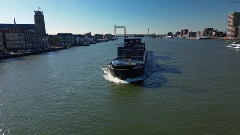Cargo-ship-Fenny-II-sailing-through-the-city-of-Dordrecht,-The-Netherlands,-aerial-shot
