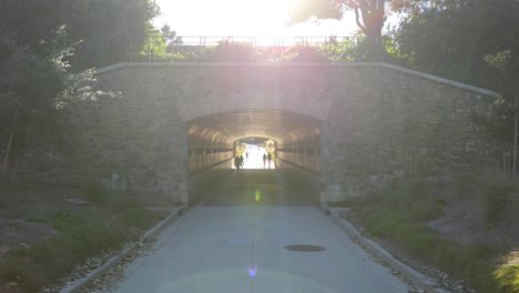 Pan-Down-of-People-Walking-Through-Jeffrey-Open-Space-Trail-Tunnel