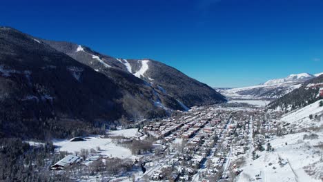 Drone-aerial-view-of-Telluride,-Colorado-with-blue-skies-in-the-winter