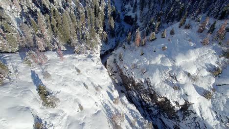 Drone-aerial-views-of-a-canyon-with-ice-outside-of-Ouray,-Colorado