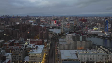 Aerial-view-flying-over-railway-tracks,-towards-the-Park-Avenue-Bridge,-in-gloomy-Harlem,-NY,-USA