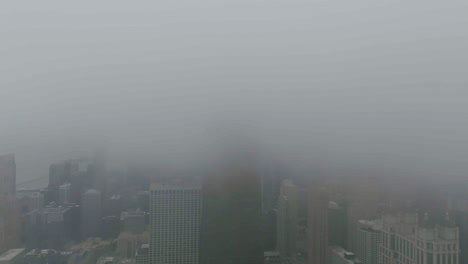 Aerial-Hyperlapse-of-thick-clouds-covering-the-Streeterville-skyline-in-Chicago,-USA