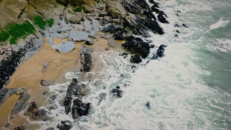 Super-slow-motion-atlantic-ocean-waves-hitting-rocks-on-a-beach