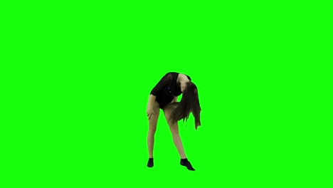 Carefree-young-happy-woman-listening-to-music-and-dancing-alone-on-green-screen-background