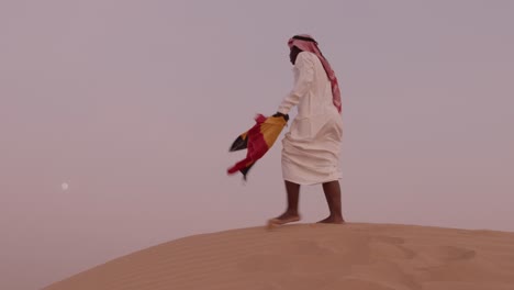 African-American-Uganda-flag-in-hand-dressed-as-arab