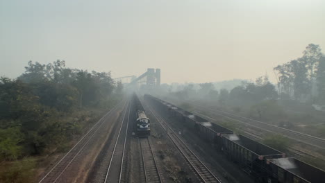still-shot-of-train-passing-behind-coal-factory