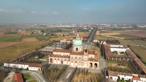 A-drone-circling-Lombardy's-Santuario-Caravaggio,-capturing-the-stunning-front-side-view-of-the-magnificent-Italian-religious-complex