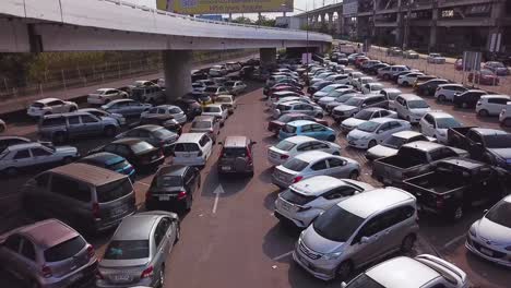 Aerial-Shot-of-a-4x4-Car-Looking-for-a-Space-to-Park-in-a-Congested-Car-Park-in-Bangkok,-Thailand