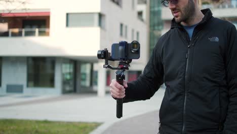 Man-filming-with-a-smartphone-on-a-gimbal