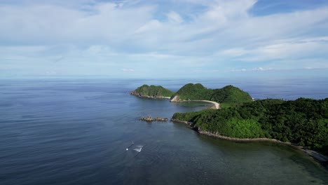 Aerial-View-of-vast-ocean-bay-with-waves-crashing-against-coastline-of-Catanduanes,-full-of-lush-jungles-and-beautiful-white-sand-beaches