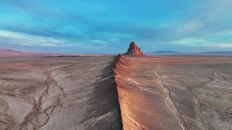Ship-Rock-Formation-In-The-Middle-Of-Vast-Desert-In-New-Mexico---aerial-drone-shot