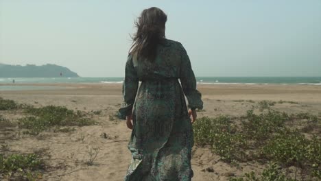 beautiful-woman-in-a-dress,-beach-and-sea-on-the-horizon,-slow-motion-shot