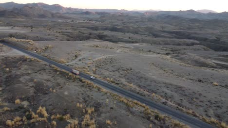 Aerial-Parallax-Tracking-Shot-Of-Vehicle-Driving-Along-RCD-Road-Through-Balochistan