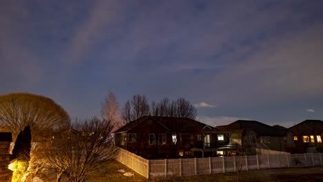 Twilight-to-moonrise-over-a-suburban-neighborhood---sliding,-panning-motion-time-lapse