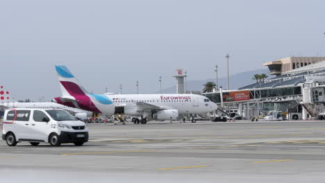 Eurowings-Airbus-A320-commercial-aircraft-arrived-to-passengers-gate-in-European-airport