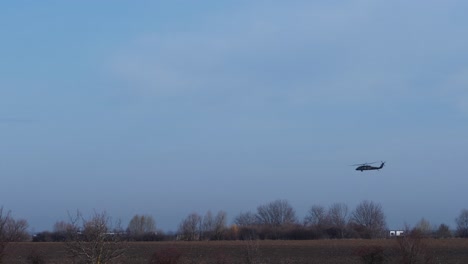 Side-View-Military-Helicopter-Moving-Slowly-Before-Landing