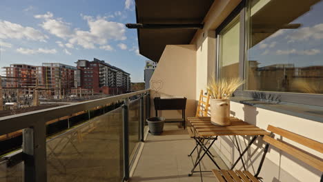 Dolly-in-through-a-big-terrace-of-a-new-apartment-in-modern-residential-sunny-area