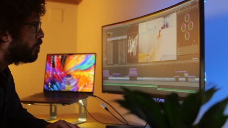 Young-adult-media-editor-busy-colour-grading-digital-film-project-on-large-studio-video-monitor