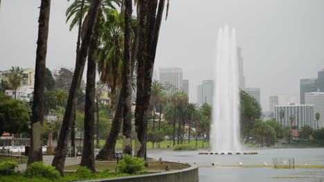 A-Wide-Shot-of-Echo-Park-Lake-in-Heavy-Rain-with-the-DTLA-Skyline-and-Palm-Trees