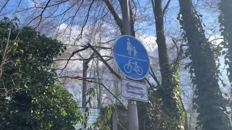 German-sign-which-points-to-a-divided-foot-and-cycle-path-in-both-directions