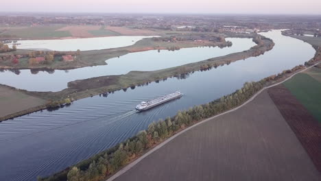 aerial-of-a-cargo-ship-sailing-on-a-river