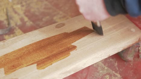 Brushing-Danish-oil-onto-Sapele-Timber-plank