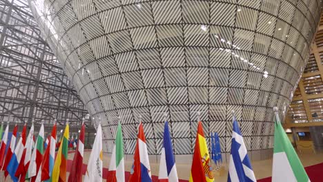 Flags-of-EU-member-state-countries-inside-European-Council-building-in-Brussels---Cinematic-panning-shot