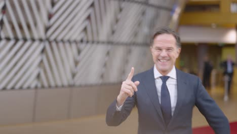 Dutch-Prime-Minister-Mark-Rutte-running-to-the-interview-stand-with-a-smile-in-the-European-Council-building-during-EU-summit---Brussels,-Belgium