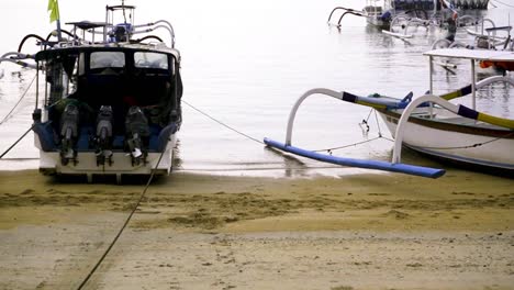 Wide-shot-of-two-fishing-boats-at-on-the-beach-of-Sanur-Harbor