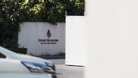 Arrive-in-style-at-Four-Seasons-Hotel-Watch-as-a-car-pulls-up-to-the-iconic-entrance-sign