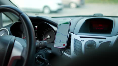 Inside-View-Of-Smartphone-Showing-Navigation-Maps-Mounted-On-Dashboard