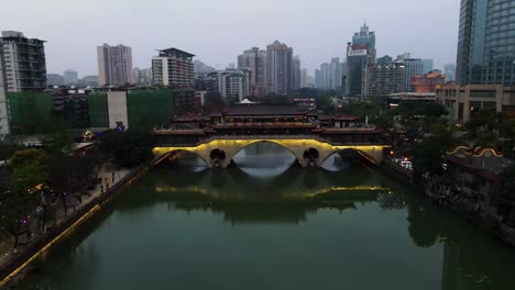 Downtown-City-Skyline-and-Anshun-Bridge-over-Jin-River-in-Chengdu,-China---Aerial-Drone-View