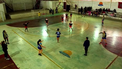 Hispanic-girls-playing-a-match-of-handball-in-the-stadium