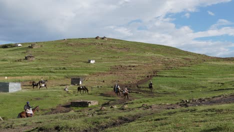 Lesotho-farmers-ride-horses-out-of-African-village-on-their-way-home