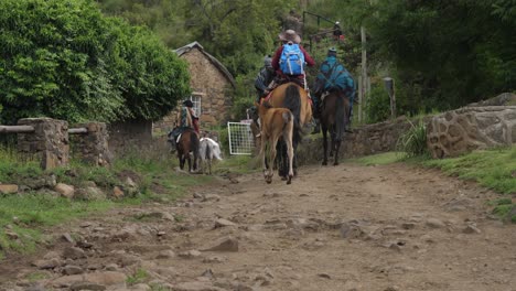 Cute-foal-follows-Lesotho-African-family-riding-horses-homeward