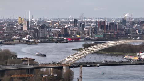 Traffic-flow-over-Van-Brienenoord-bridge,-Rotterdam-skyline-aerial-view