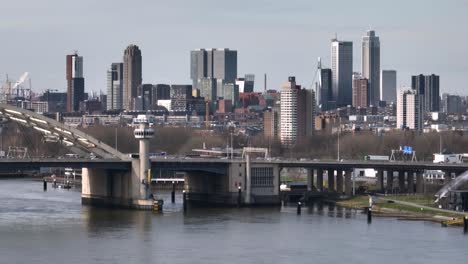 Aerial-voiew-showing-skyline-of-Rotterdam-and-traffic-on-Van-Brienenoord-bridge-durign-sunny-day