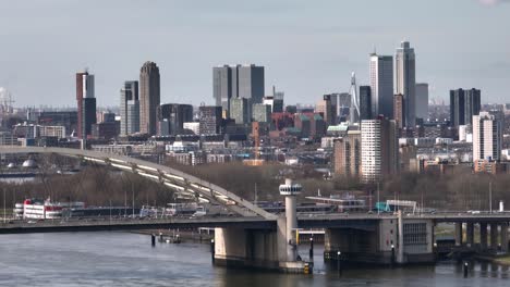Skyline-of-Rotterdam-With-the-Van-Brienenoord-Bridge-in-the-Foreground,-Aerial-Establishing-Shot
