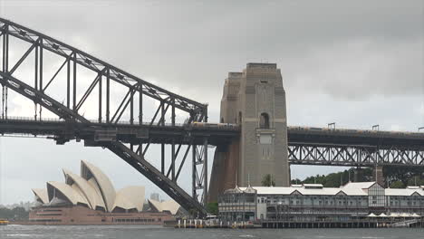 A-train-passes-over-the-Sydney-Harbour-Bridge-on-a-cloudy-rainy-day,-Australia