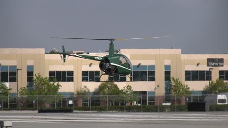 Helicopter-practicing-flight-maneuvers-over-runway