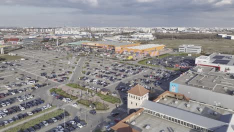 Aerial-flyover-parking-area-with-cars-at-shopping-center-and-Hornbach-diy-market-in-Bucharest