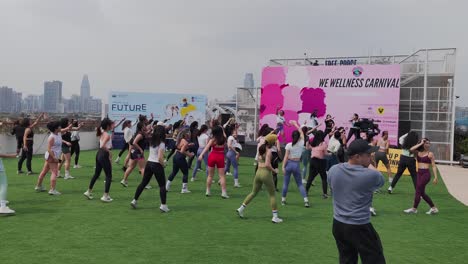 Women-doing-fitness-workout-activity-at-open-air-women-empowerment-event,-Guangzhou,-china
