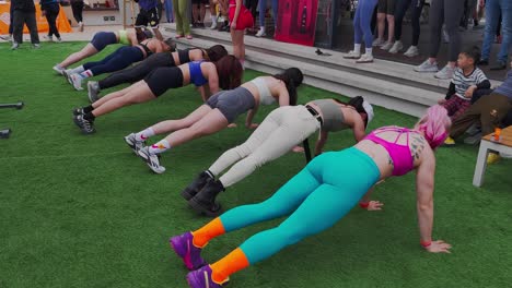 Women-competing-in-push-ups-challenge-during-open-air-fitness-event